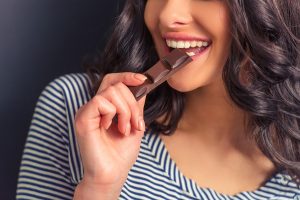 Smiling, white teeth, and eating chocolate